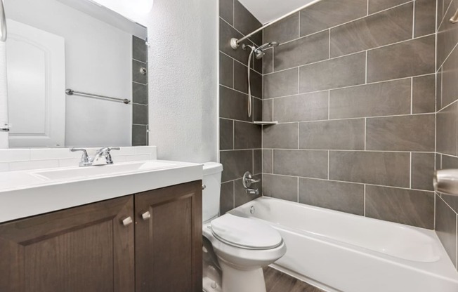 a bathroom with a sink toilet and bath tub