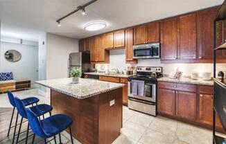 A kitchen with wooden cabinets and a granite countertop.