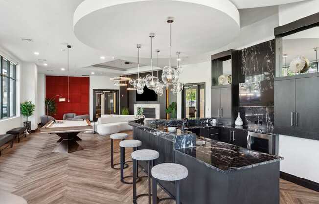 A modern kitchen with a bar area and a living room area.