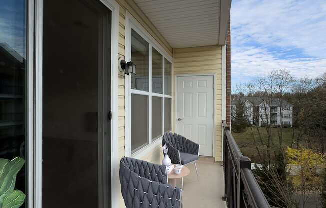 Modern apartment balcony at Queens Gate Apartments Rental Complex in Bound Brook, NJ with a spacious layout, featuring outdoor seating and scenic views. Ideal for relaxation and city living with an open-air feel.