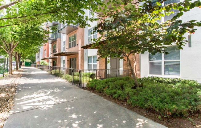 our apartments are located in a quiet area with a sidewalk and trees