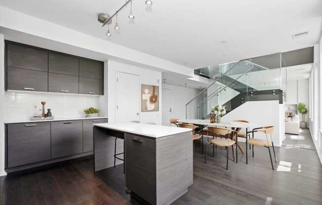 a kitchen with a large island and a dining table