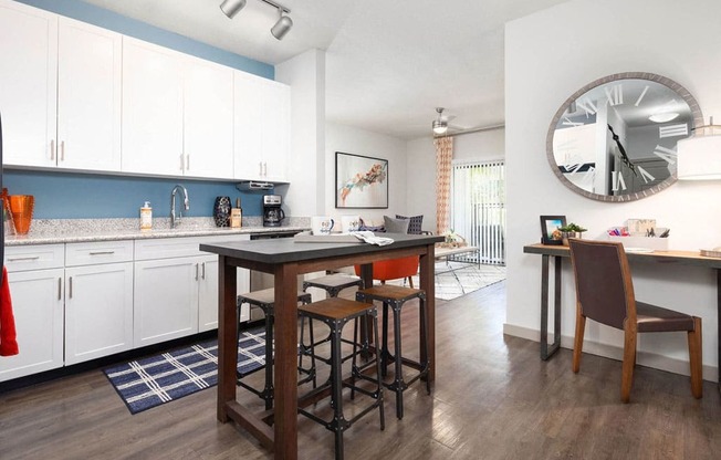 a kitchen and dining room with a large clock on the wall