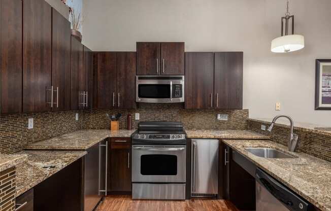 a kitchen with granite counter tops and stainless steel appliances