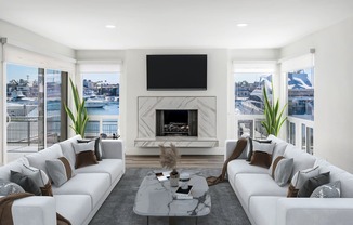 a living room with white couches and a fireplace