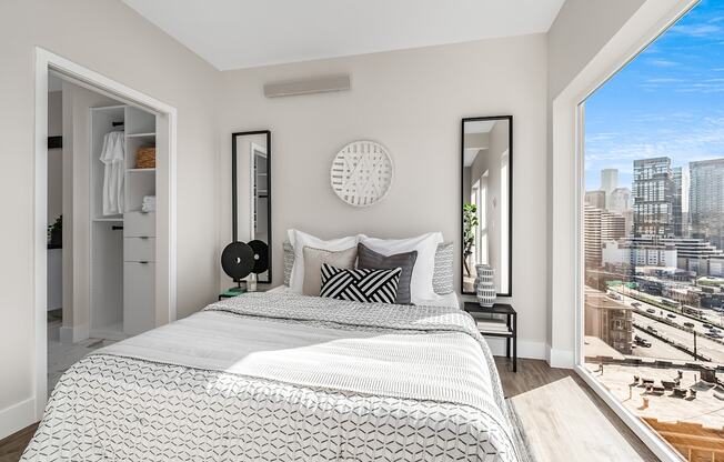 a bedroom with a bed and a large window  at Oslo, Seattle, WA, 98102