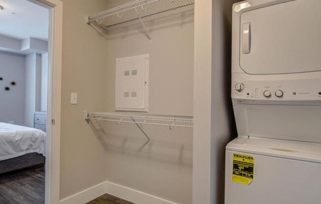 a white washer and dryer in a room next to a bedroom at Barrington 101, Illinois, 60010