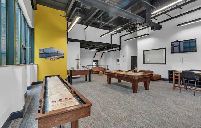 A room with a pool table and a yellow wall.