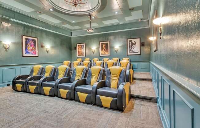 Theater room with blue and yellow chairs and a chandelier at Vintage Park Apartments, Texas