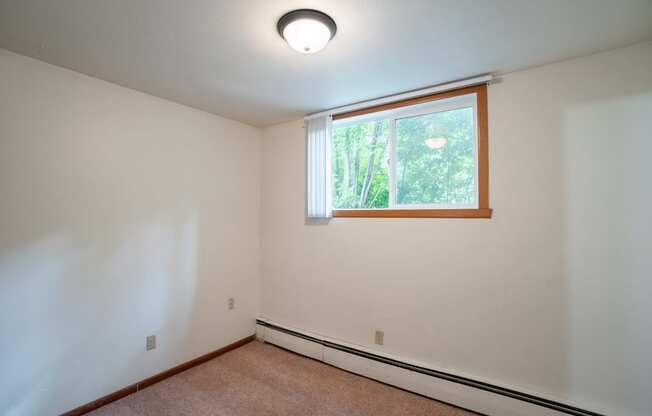 an empty room with a window and white walls. Fargo, ND Luxford Apartments