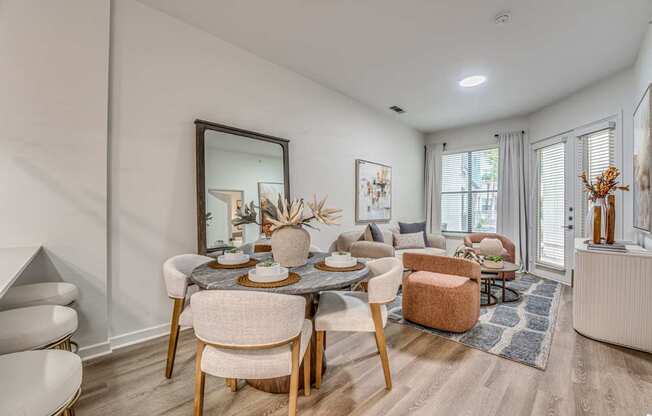 A dining room with a round table and chairs.
