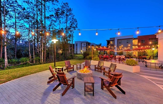 a patio with a fire pit and a lot of chairs at Luxor Club, Jacksonville, 32258