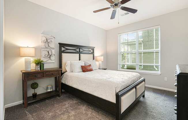 a bedroom with a bed and a ceiling fan