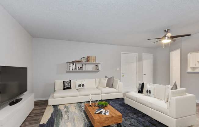 a living room with two white couches and a coffee table  at Eastwood Crossings, Missouri