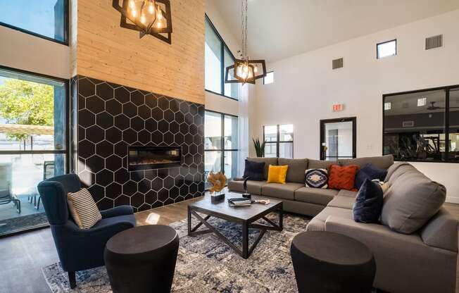 a living room with couches and chairs and a fireplace