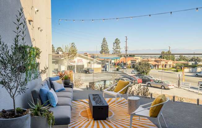 a living room with a couch and a table on a balcony