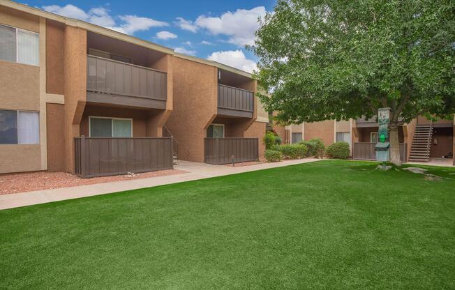 a large lawn in front of a brick building