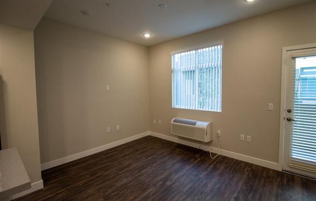 a bedroom with hardwood floors and a window at Loma Villas Apartments, San Bernardino, 92408