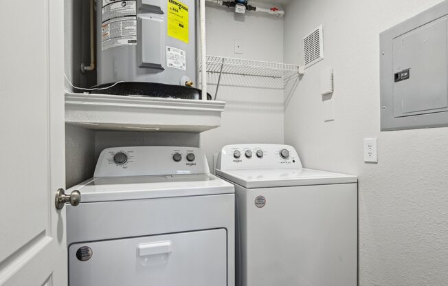 A white washing machine and dryer in a small laundry room.