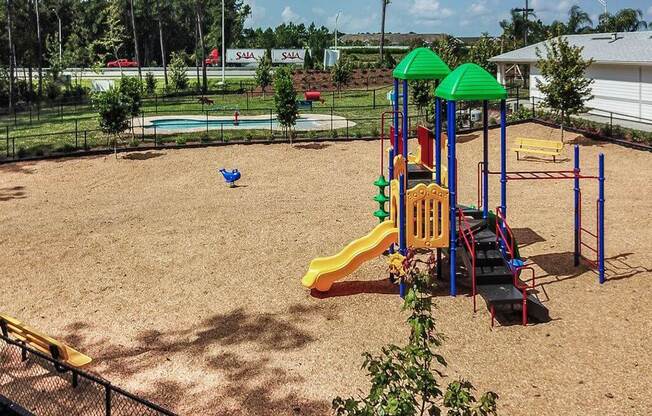 a playground with a slides and a monkey bars  at Palm Bay Club, Florida