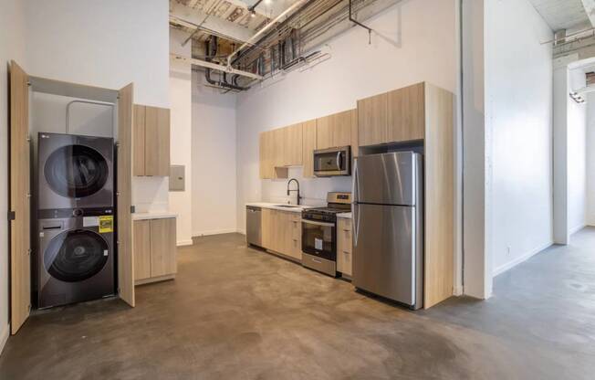 a kitchen with a washing machine and a refrigerator