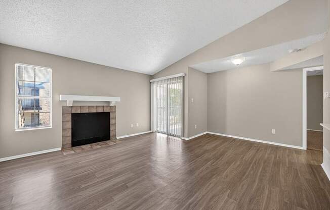 A living room with a fireplace and sliding glass doors.