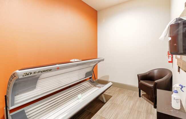 a patient room with a bench and a chair in a hospital room at Cumberland Place Apartment Homes, Texas