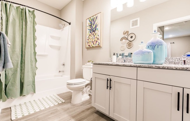 a bathroom with a shower and a toilet and a sink