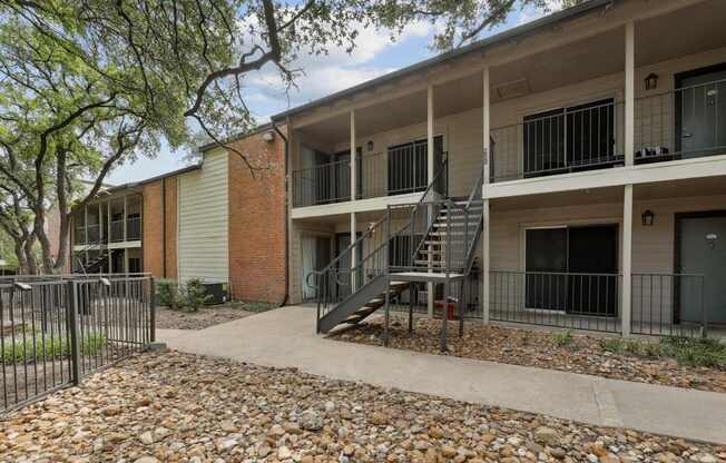 Apartment entrances with stairway at Westdale Pointe in Austin, TX