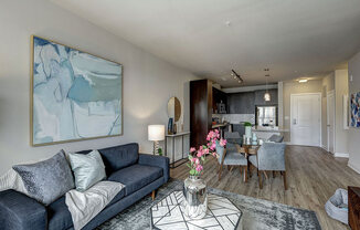 Spacious Living room with a couch and a coffee table at Highgate At The Mile near Tysons, VA