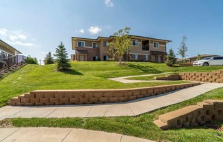 Villa building on top of green hill at Villas of Omaha townhome apartments in northwest Omaha NE 68116