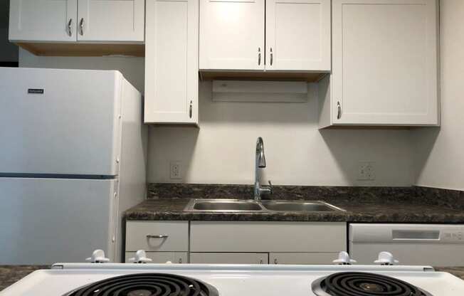 a kitchen with a stove top oven next to a refrigerator