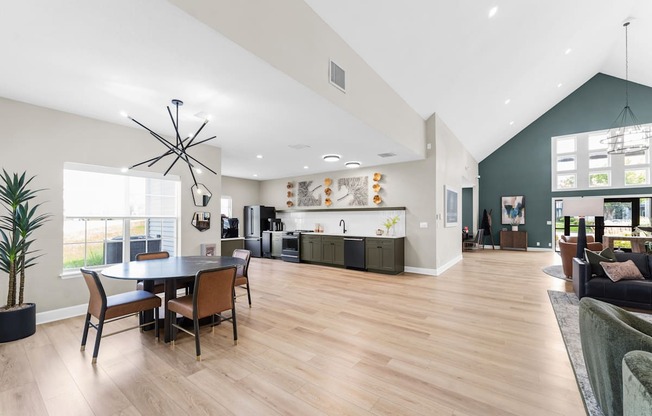 A modern open plan living and dining room with wooden floors and furniture.