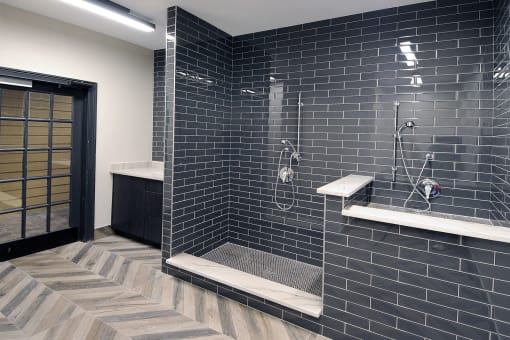 a black tile bathroom with a shower and a sink at Willowest in Collier Hills, Georgia, 30318