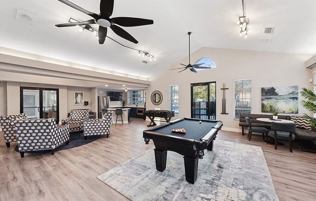 Community Clubhouse with Lounge Furniture and Pool Table Area at Vue at Baymeadows Apartments in Jacksonville, FL.