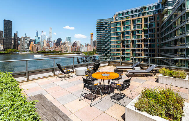 Luxury roof deck rental amenity with skyline views, seating, and lounge furniture. 