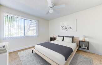 a bedroom with a bed and a ceiling fan at Redlands Park Apts, California