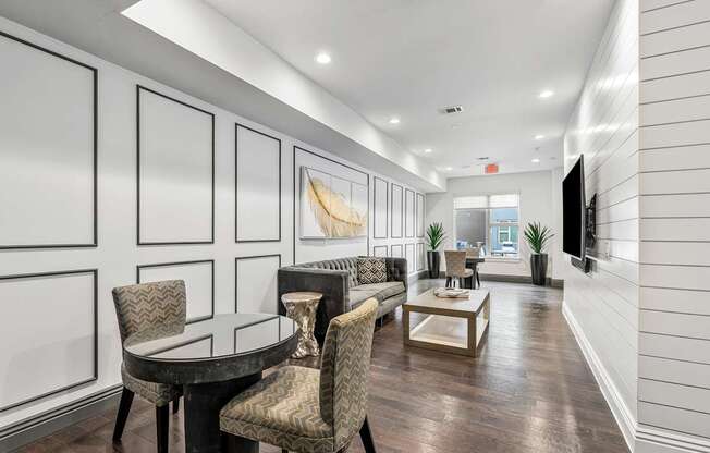A modern dining room with a glass table and chairs.