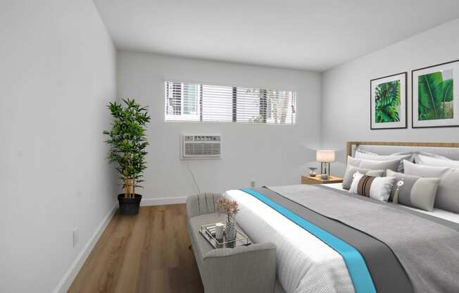 a bedroom with white walls and a large bed with a blue blanket