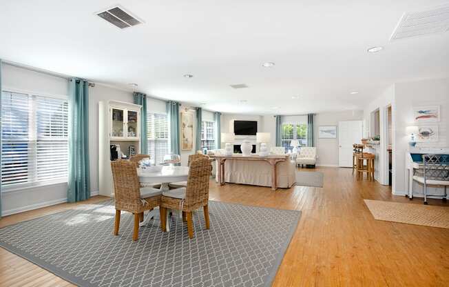 A modern dining room with a table set for four.