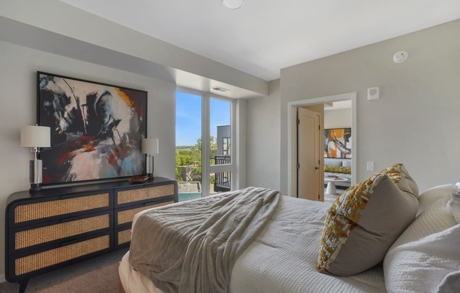 a bedroom with a large bed and a large window