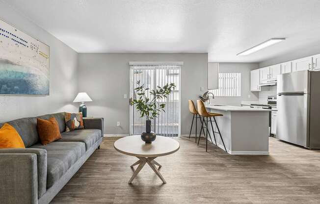 A living room with a grey couch and a white coffee table.
