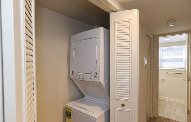 an empty laundry room with a washer and dryer