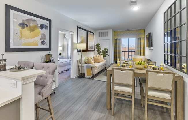 a living room and dining room with a table and chairs