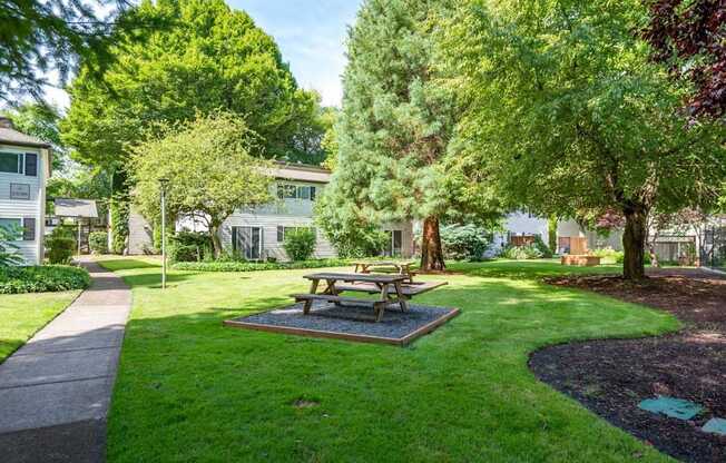 A picnic table sits in the middle of a grassy area.
