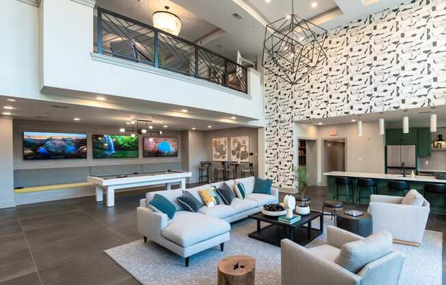 a living room with couches and chairs and a pool table