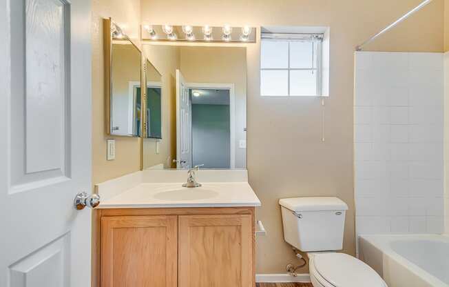 a bathroom with a sink toilet and a mirror