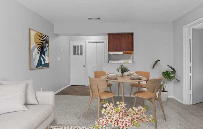 a living room and dining room with a table and chairs