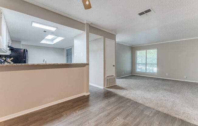a living room with hardwood floors and a large window