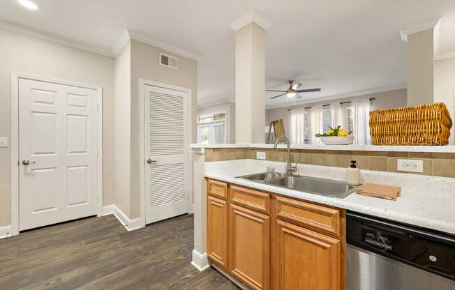 a kitchen with a sink and a door to a living room at The Verandah, Austin, 78726